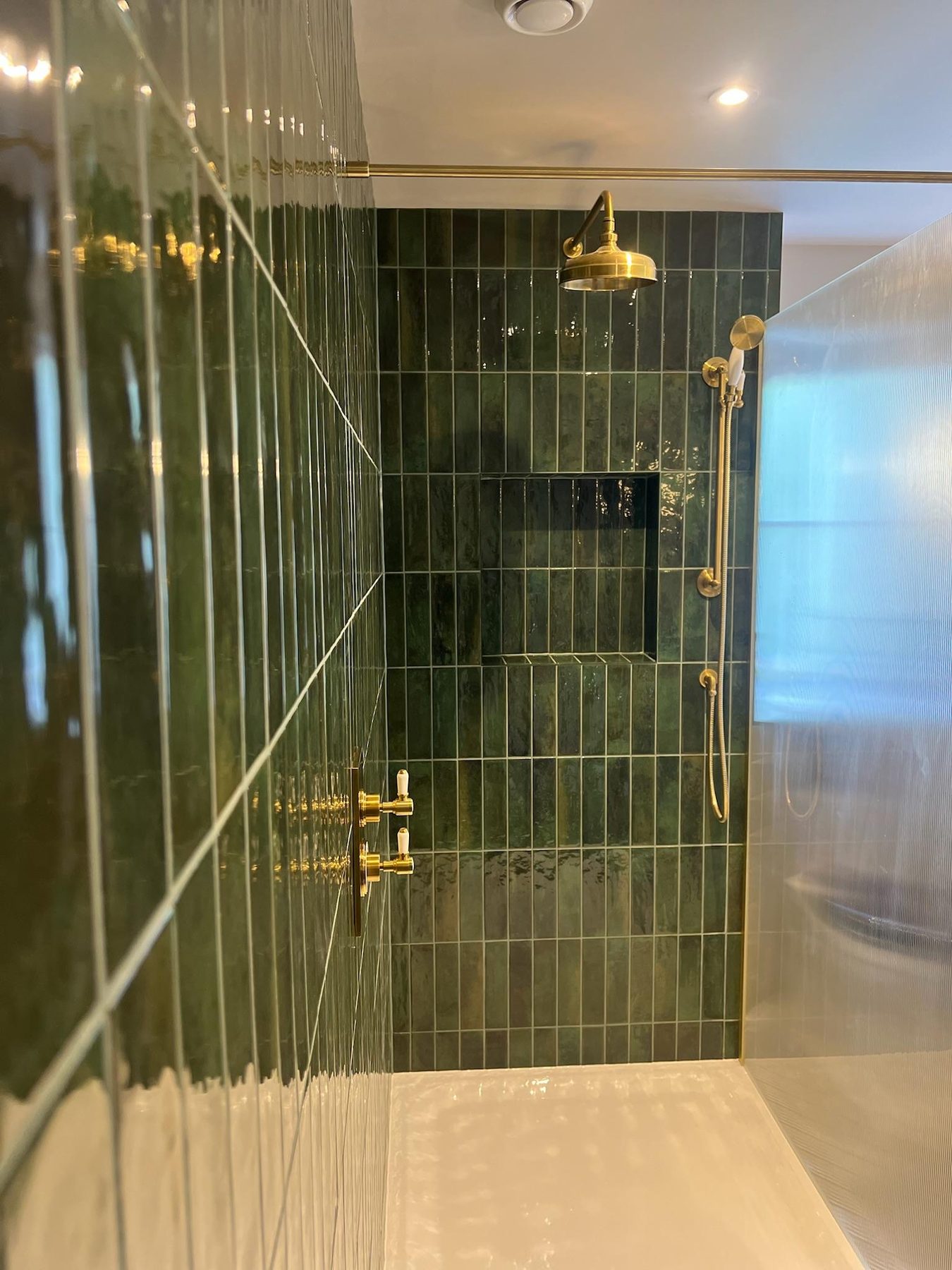 Walk-in shower with green tiles