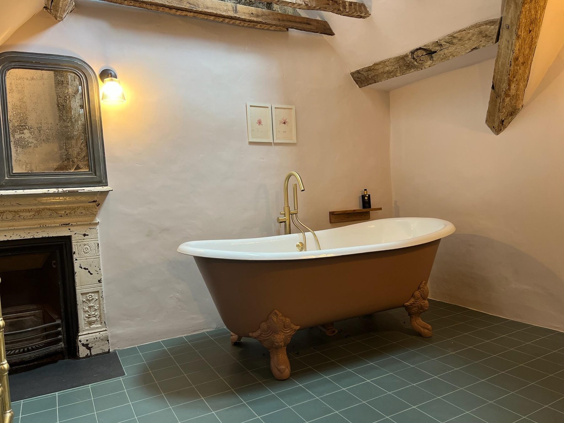 Freestanding bath in front of a fireplace