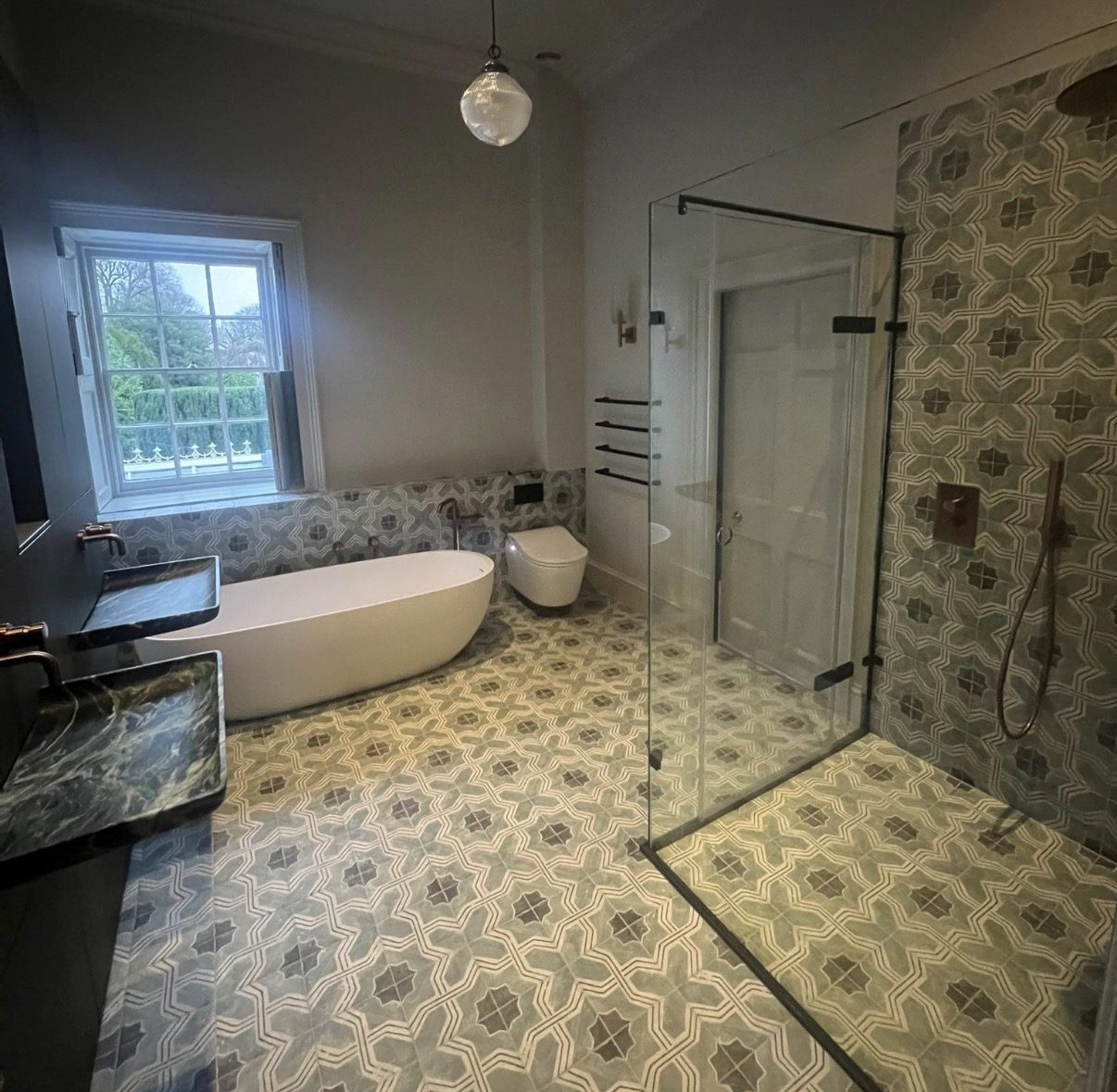 Freestanding bath, patterned floor and walk-in shower