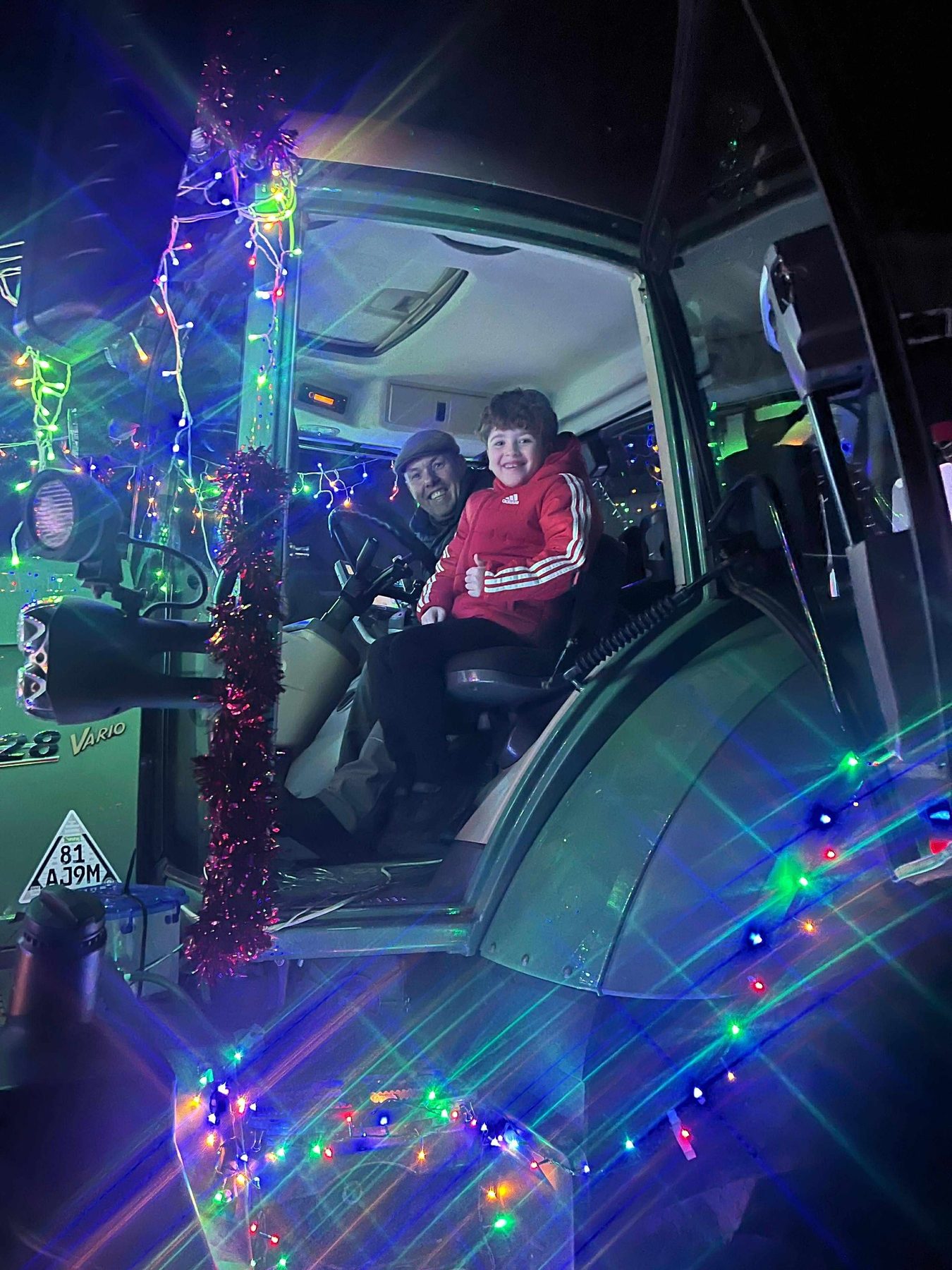 Luke’s son in the cab of the sponsored tractor