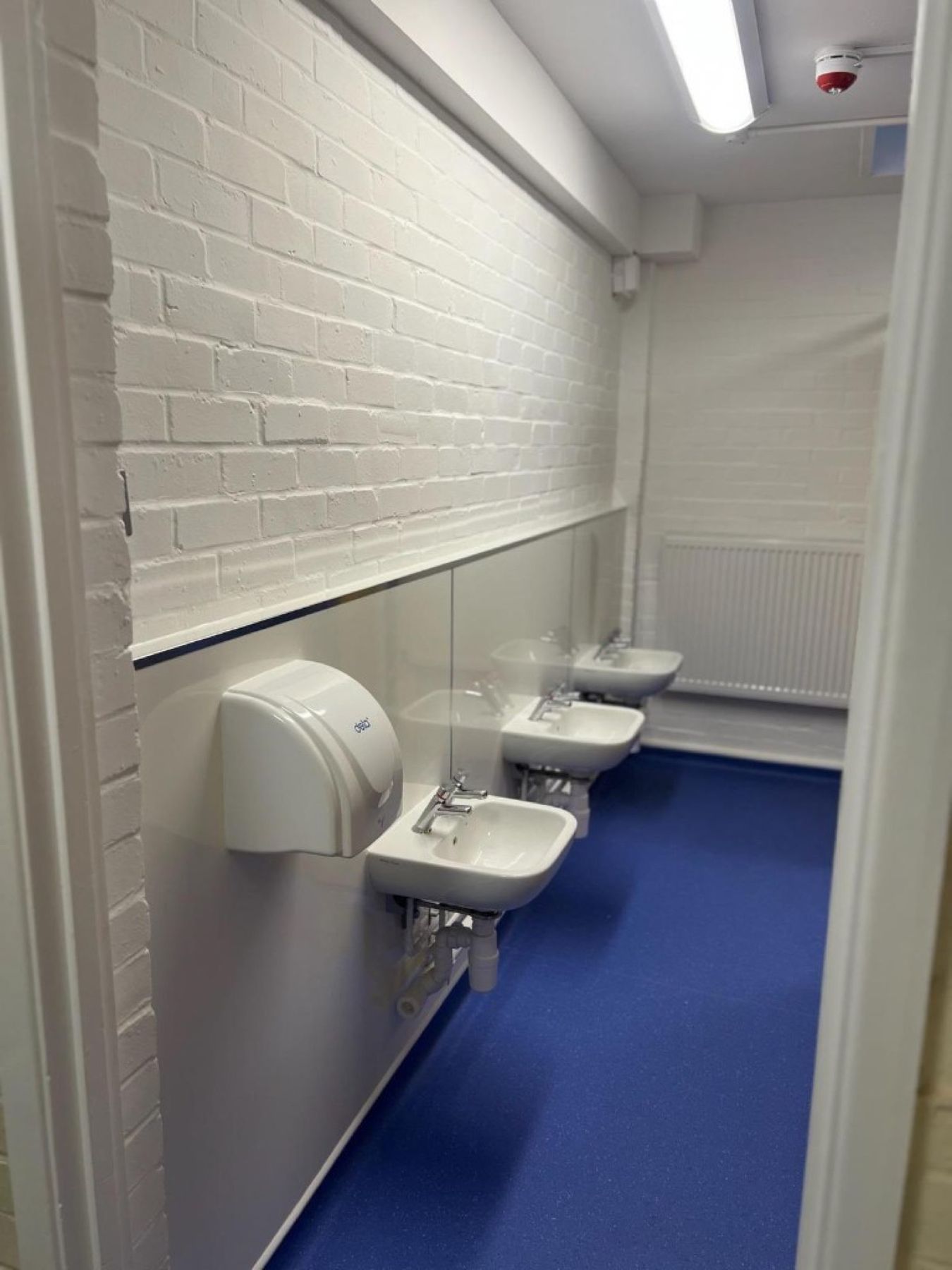 Pupil washroom looking through to the basin run