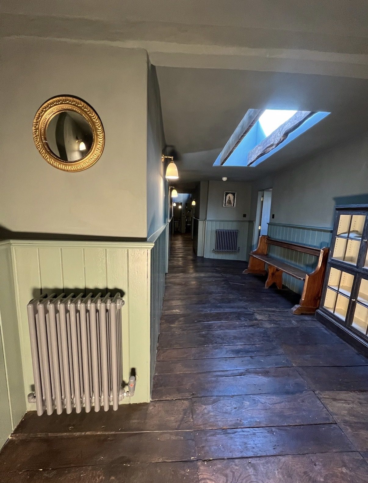 Finished hallway with a column radiator