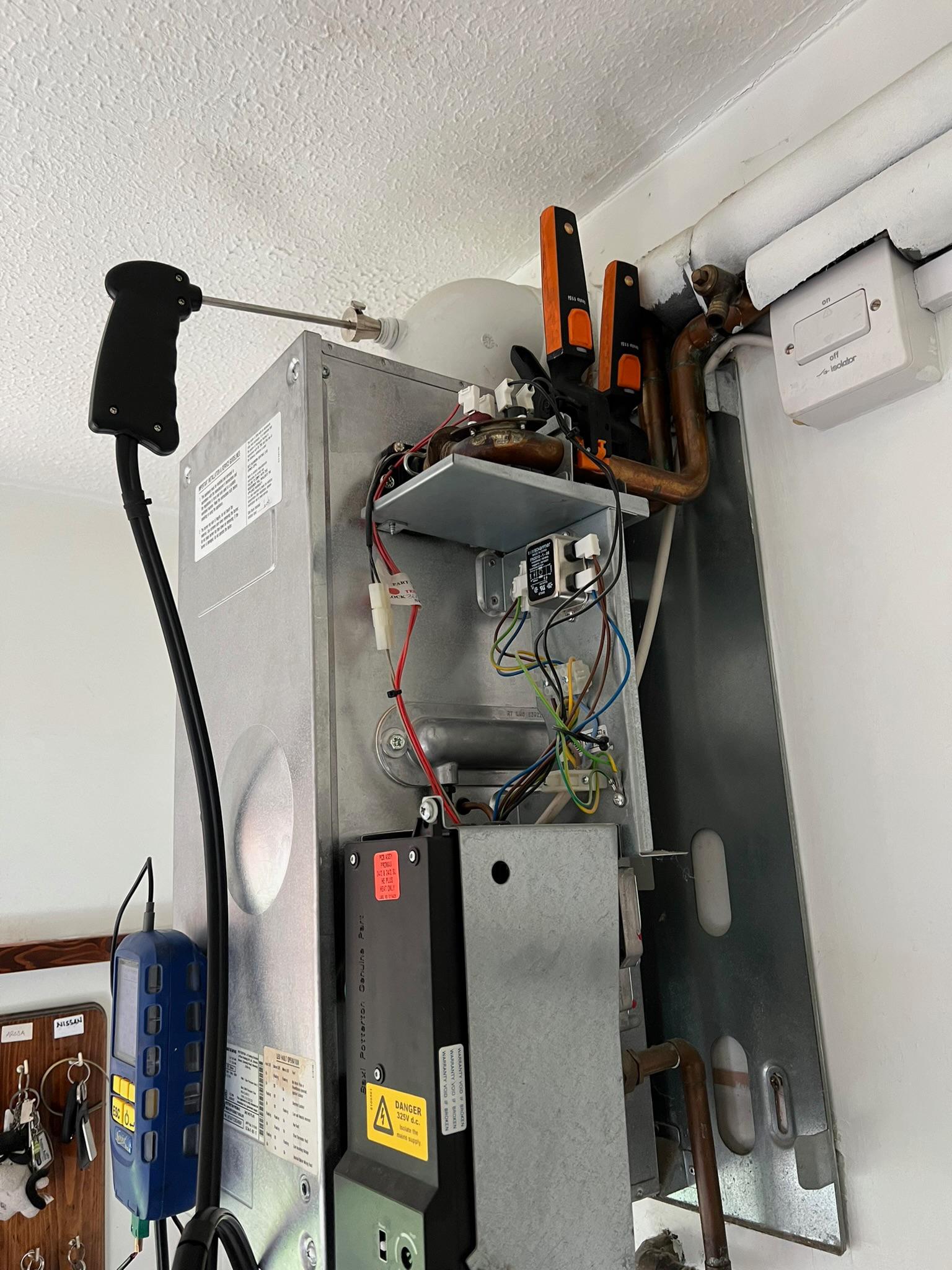 Open gas boiler during a service and safety check