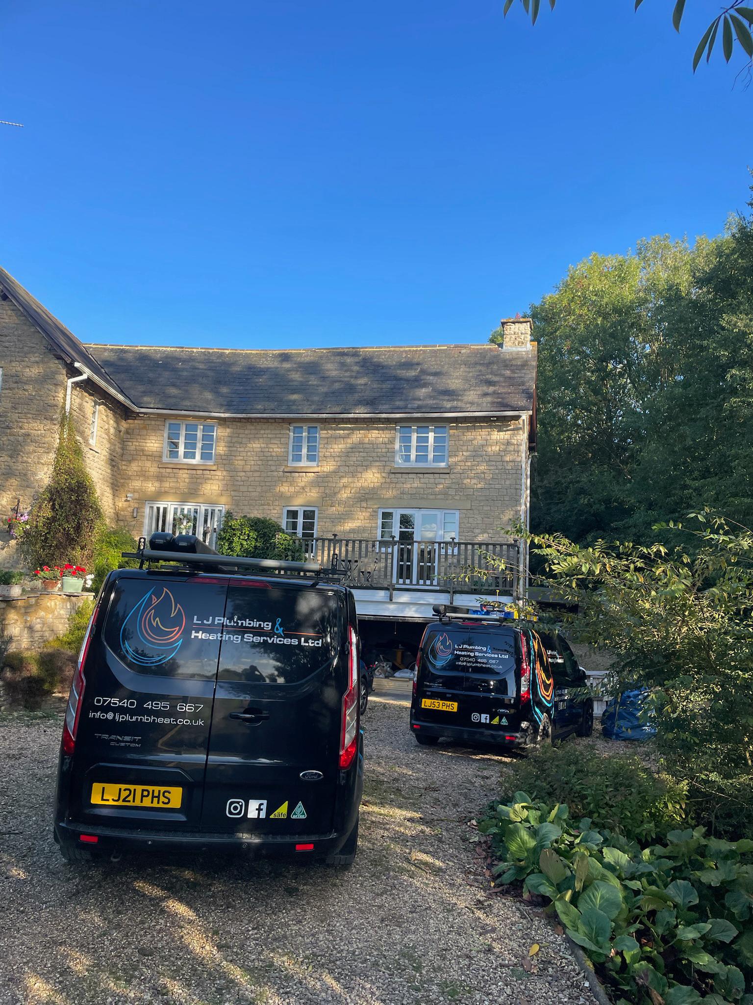 LJ Plumbing & Heating vans on site